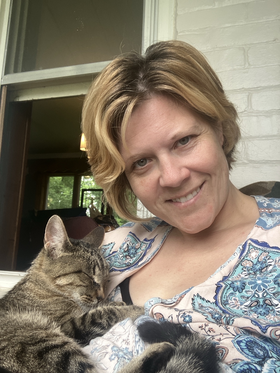Kati Shaw on her porch with her cat